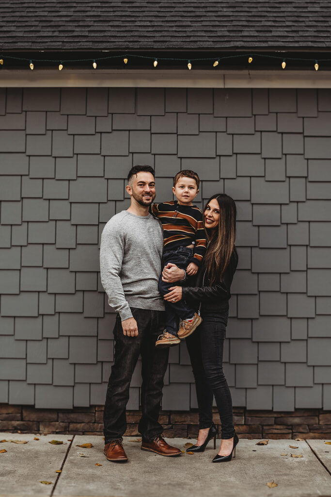 Baltimore Photographers capture family standing against wall holding son