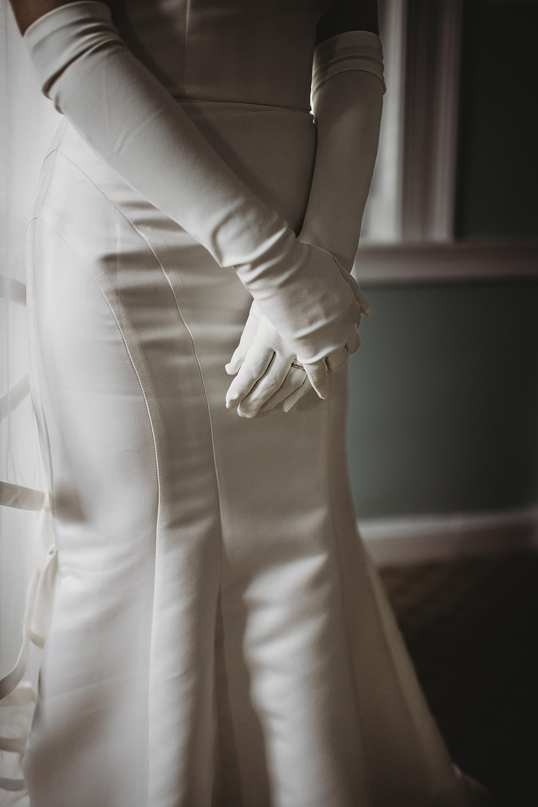Baltimore wedding photographers capture bride wearing white gloves and wedding dress