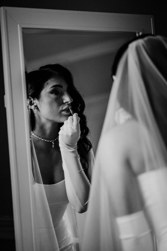 Baltimore wedding photographers capture bride putting lipstick on