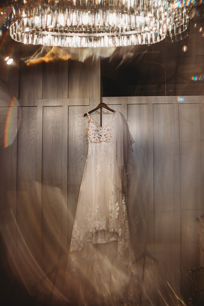 Maryland wedding photographer captures wedding dress hanging before wedding ceremony at Ellicott City Wedding Venue