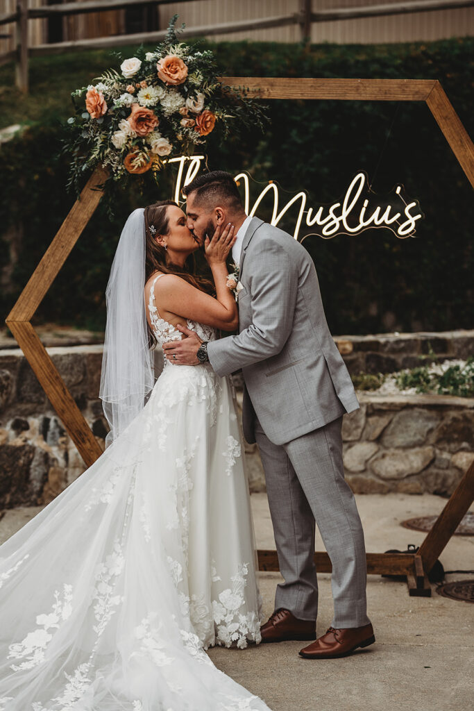 Maryland wedding photographer captures bride and groom kissing at alter