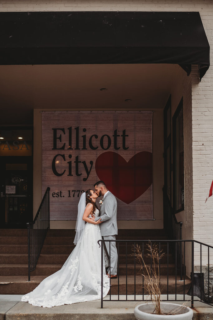 Maryland wedding photographer captures couple kissing outside of Ellicott City wedding venue