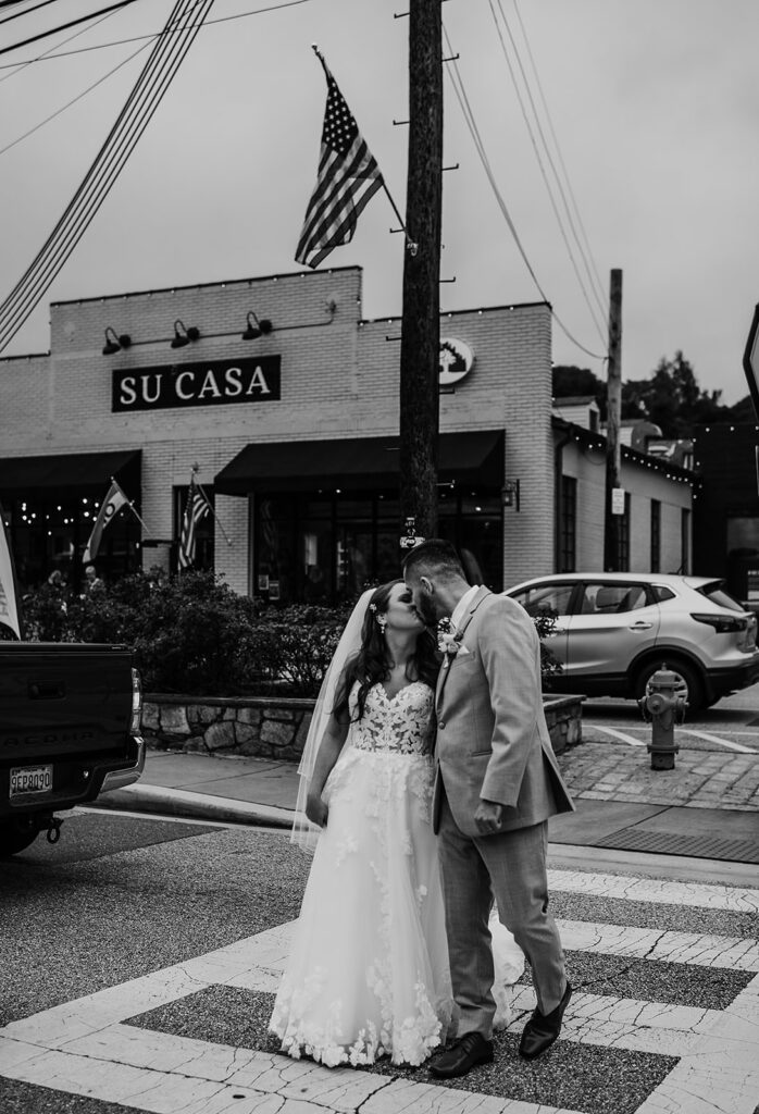 Maryland wedding photographer captures black and white portrait of bride and groom crossing street