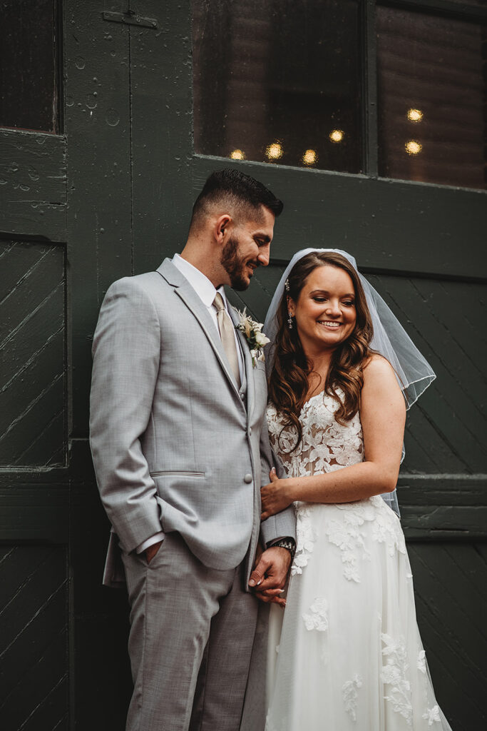 Maryland wedding photographer captures groom looking at bride during outdoor bridal portraits