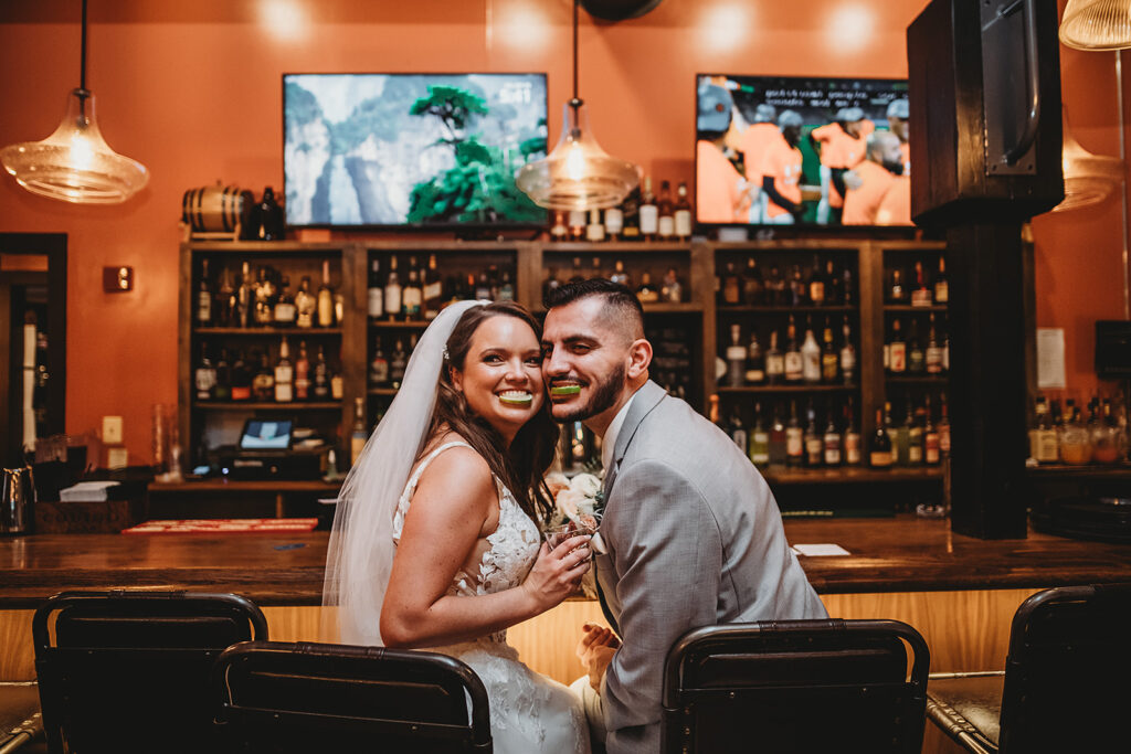 Maryland wedding photographer captures newly married couple laughing together at evening reception