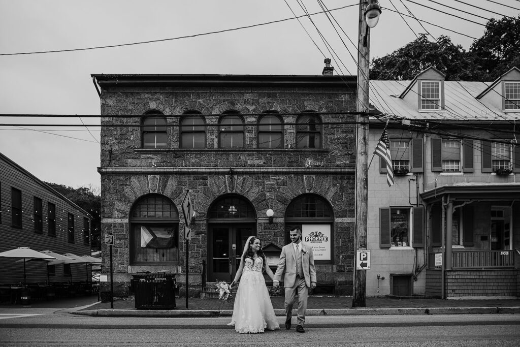 Maryland wedding photographer captures bride and groom walking together in black and white portrait