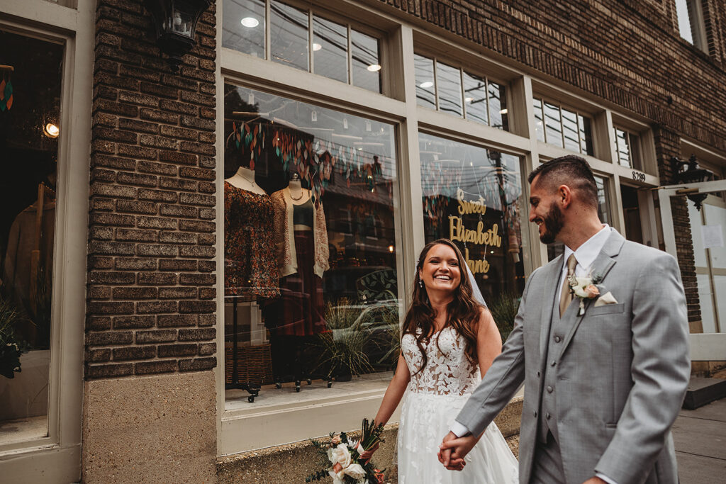 Maryland wedding photographer captures couple walking down street holding hands after wedding ceremony