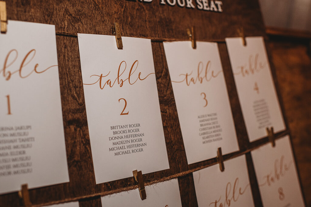 Maryland wedding photographer captures seating chart hanging with clothespins