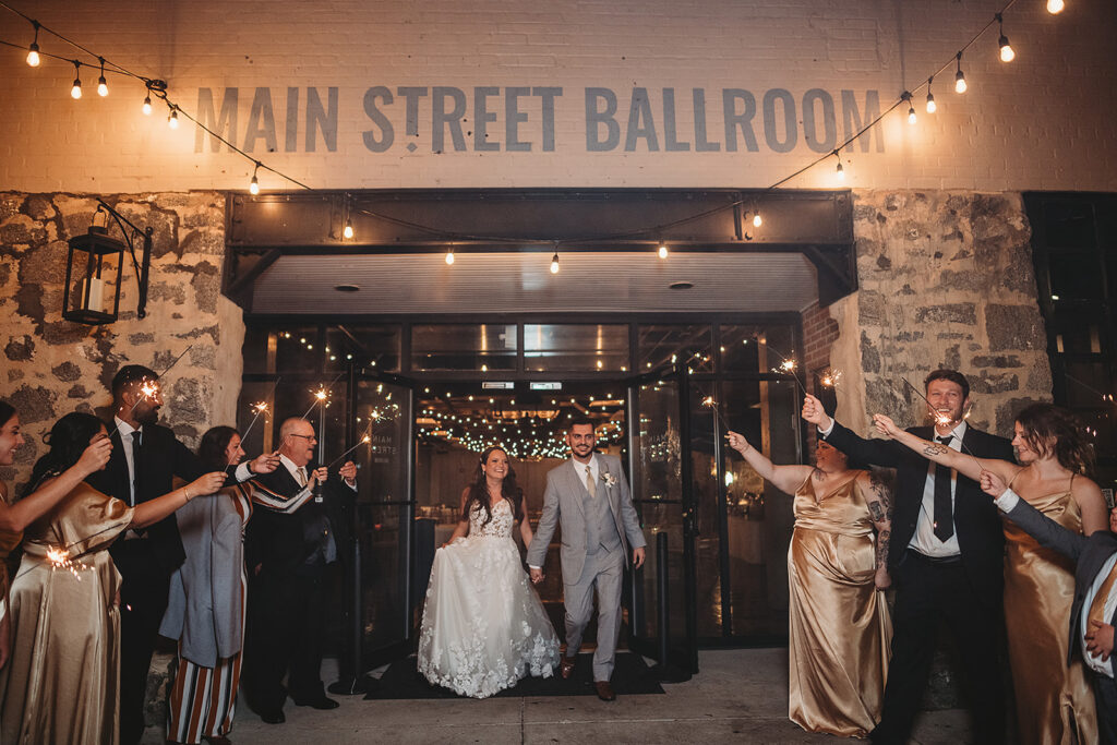 Maryland wedding photographer captures bride and groom leaving Ellicott City wedding venue during sparkler exit