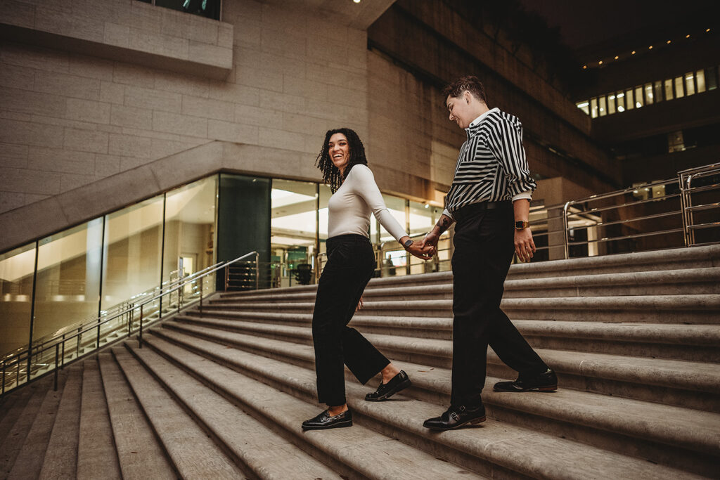Maryland engagement photographer captures couple walking downstairs hand in hand