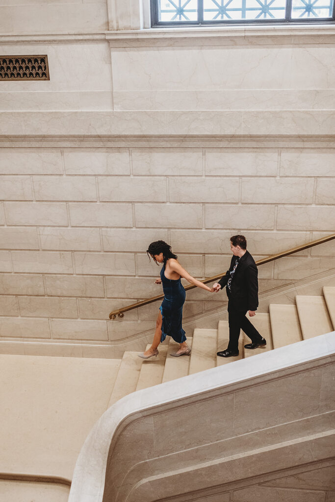 Maryland engagement photographer captures woman leading fiance downstairs