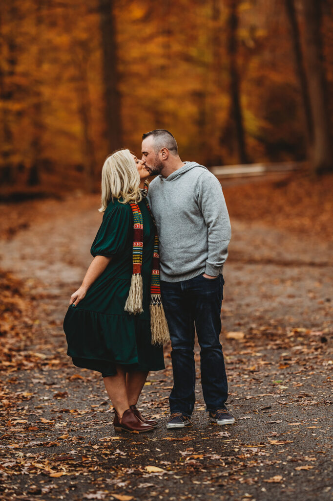 Baltimore photographers capture couple kissing during fall portraits