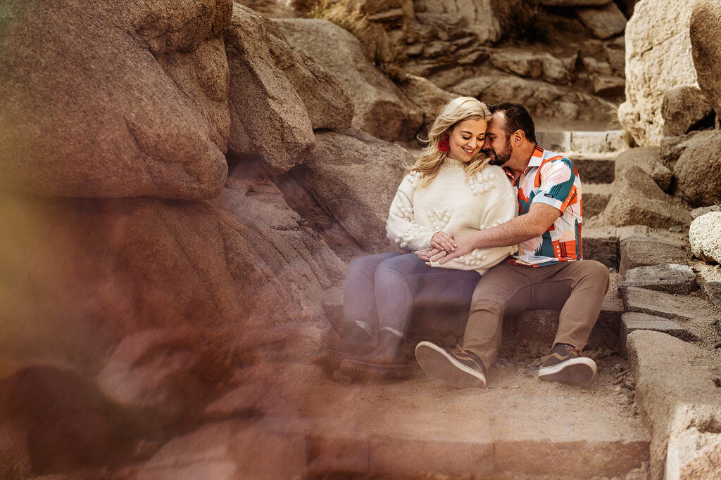 Baltimore photographers capture couple sitting on boulders during portraits