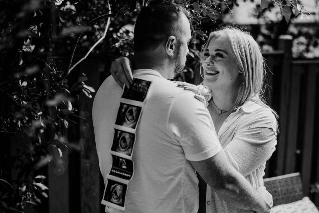 Baltimore photographers capture black and white portrait of couple announcing pregnancy
