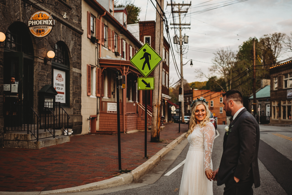 Baltimore photographers capture bride and groom walking across street holding hands