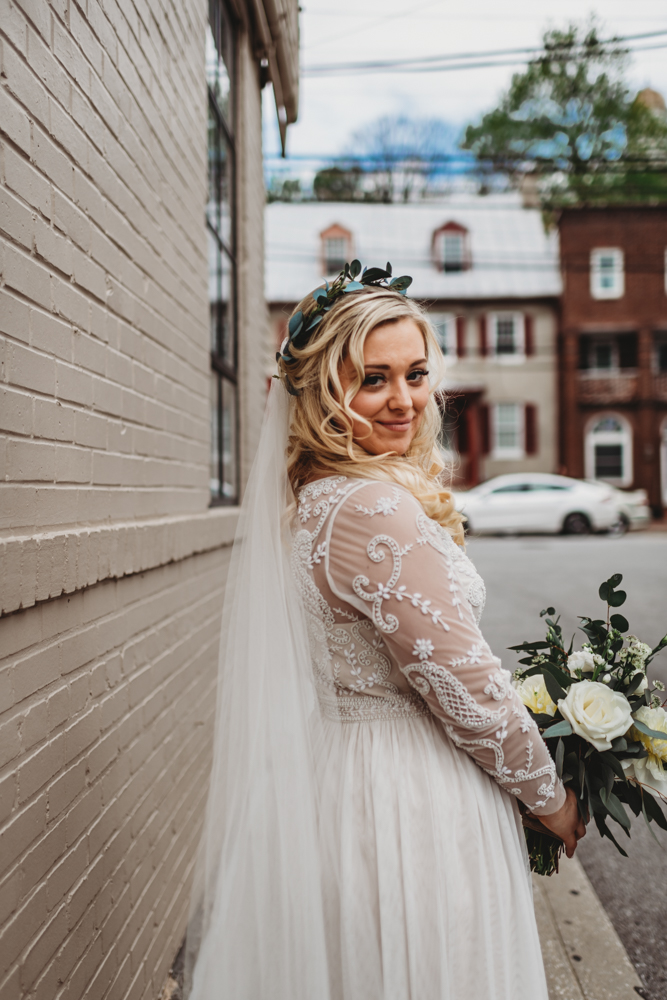 Baltimore photographers capture bride wearing wedding dress holding bouquet