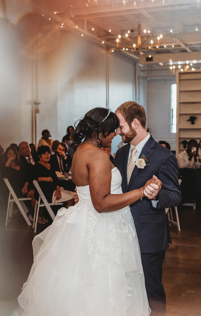 Baltimore wedding photographers capture bride and groom dancing together at Haven Street Ballroom wedding