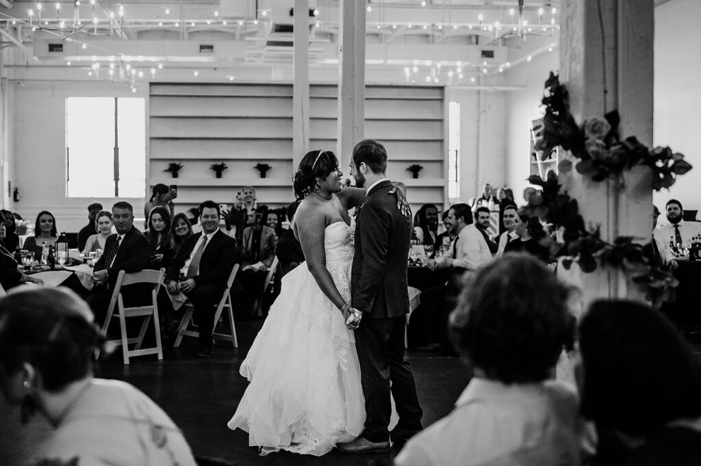 Baltimore wedding photographers capture bride and groom dancing during first dance at Haven Street Ballroom wedding