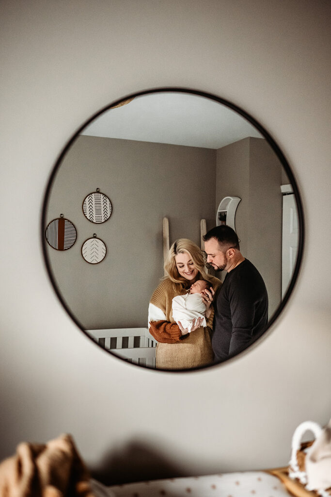 Baltimore photographers capture couple in mirror holding baby