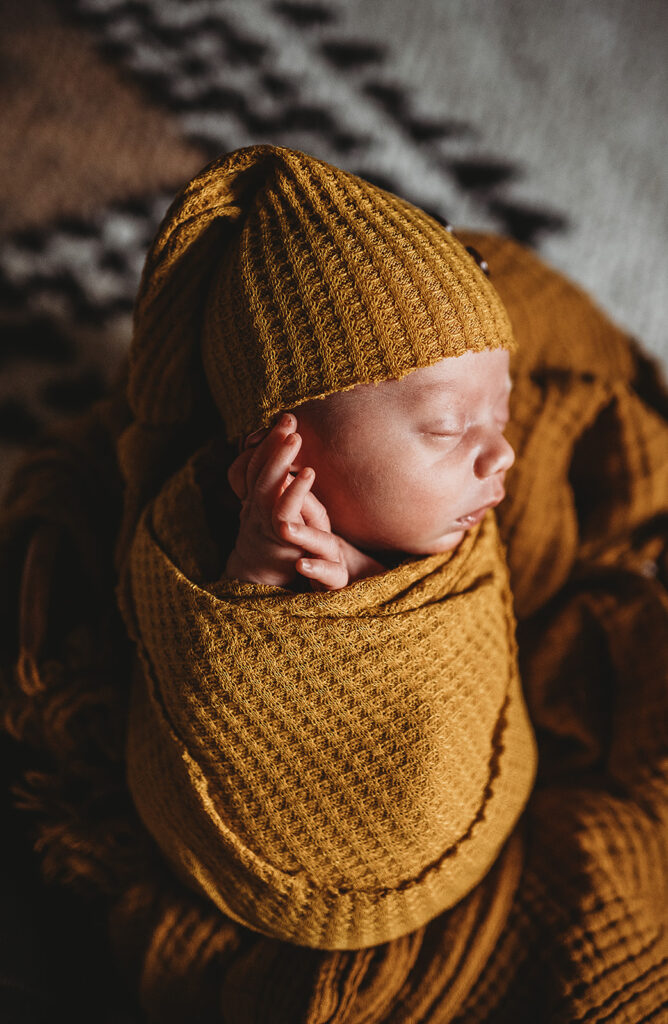Baltimore photographers capture baby swaddled in mustard swaddle