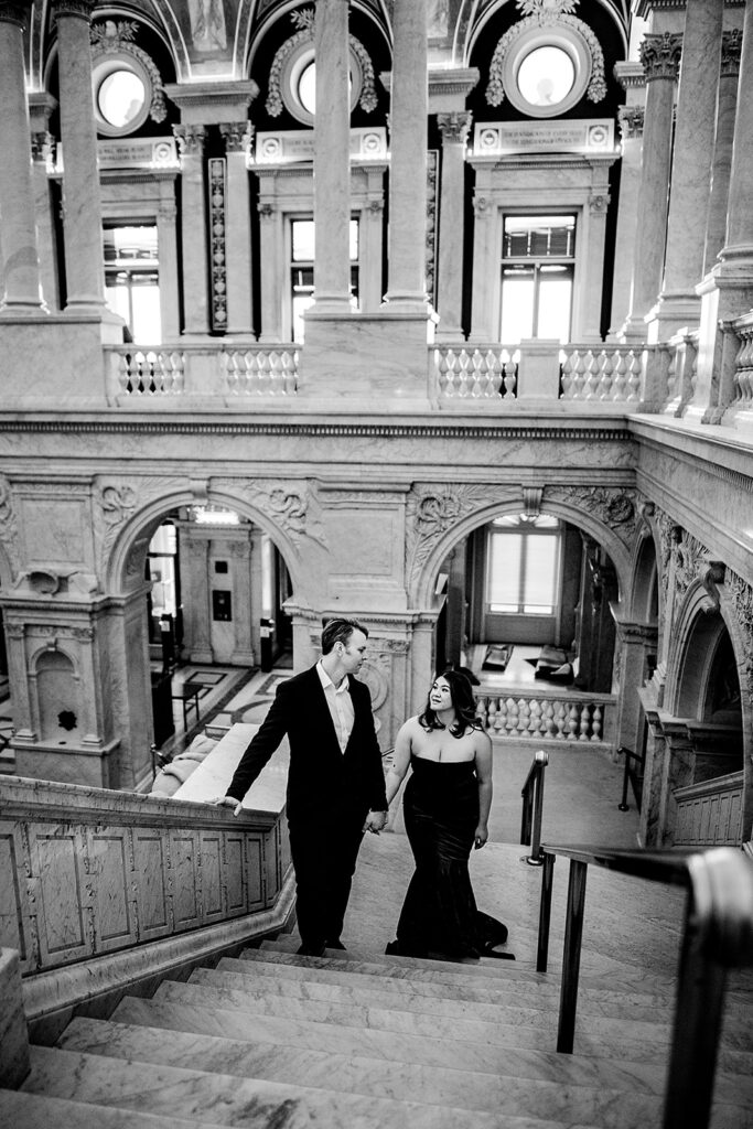 Baltimore wedding photographer captures black and white portrait of couple walking up stairs at Library of Congress
