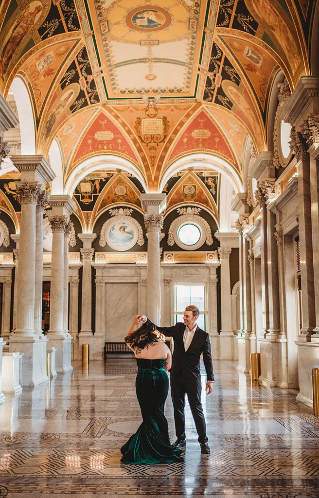 Baltimore wedding photographer captures groom spinning bride while dancing together in library of congress