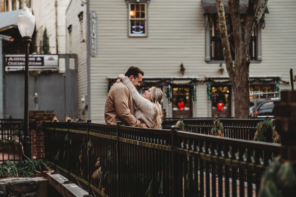 Maryland engagement photographer captures man and woman embracing during Christmastime engagement photos