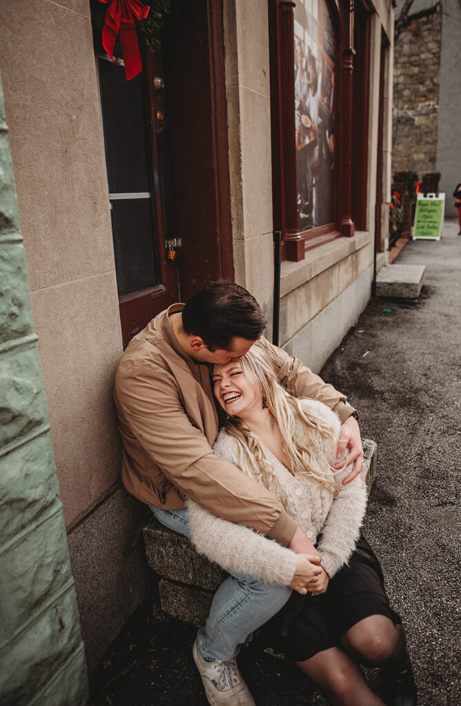 Baltimore photographer captures man cuddling woman during Ellicott City engagement photos