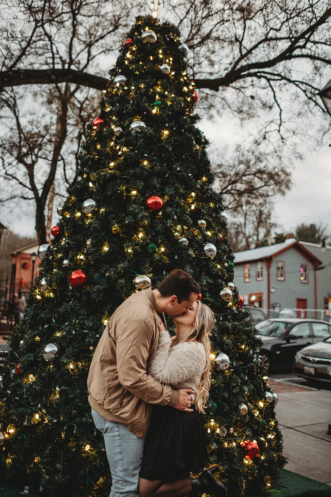 Maryland wedding photographer captures couple kissing in front of Christmas tree