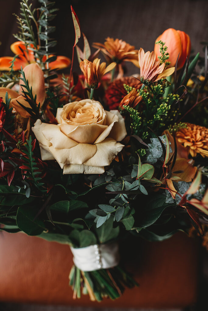 Baltimore wedding photographer captures warm-colored floral bridal bouquet