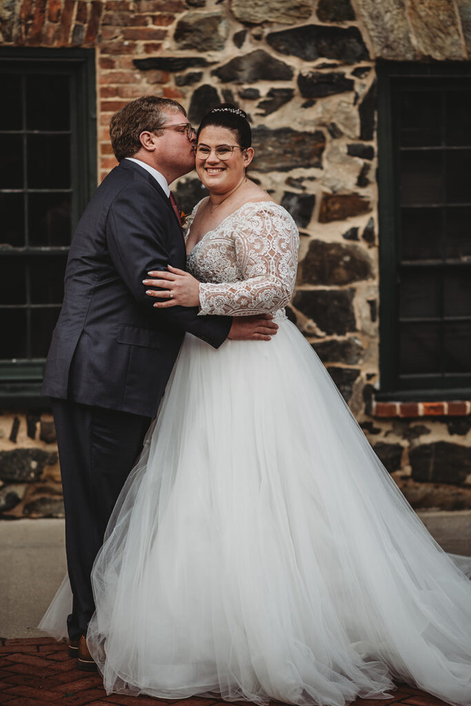Baltimore wedding photographer captures groom kissing bride's cheek