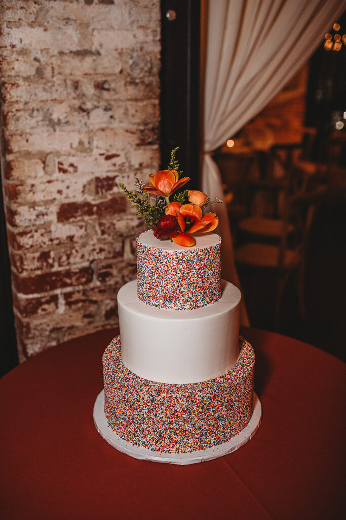 Baltimore wedding photographer captures wedding cake with flowers and sprinkles