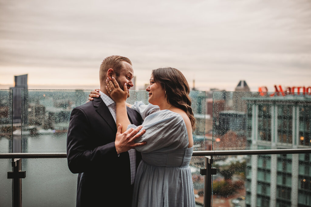 Baltimore wedding photographer captures couple embracing on balcony 