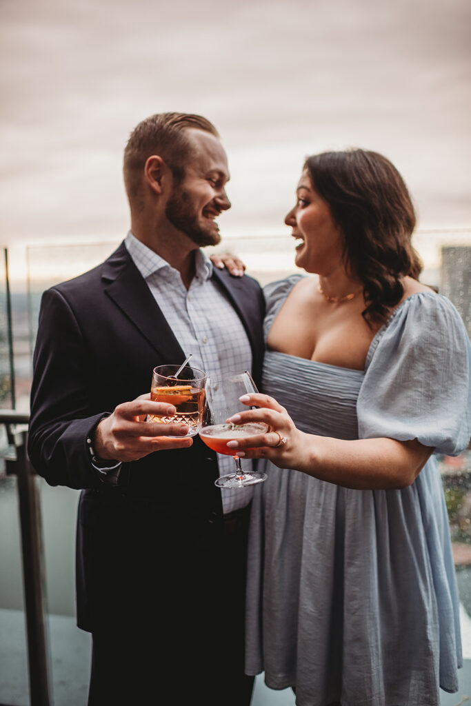 Baltimore Wedding Photographer captures newly engaged couple celebrating engagement with drinks