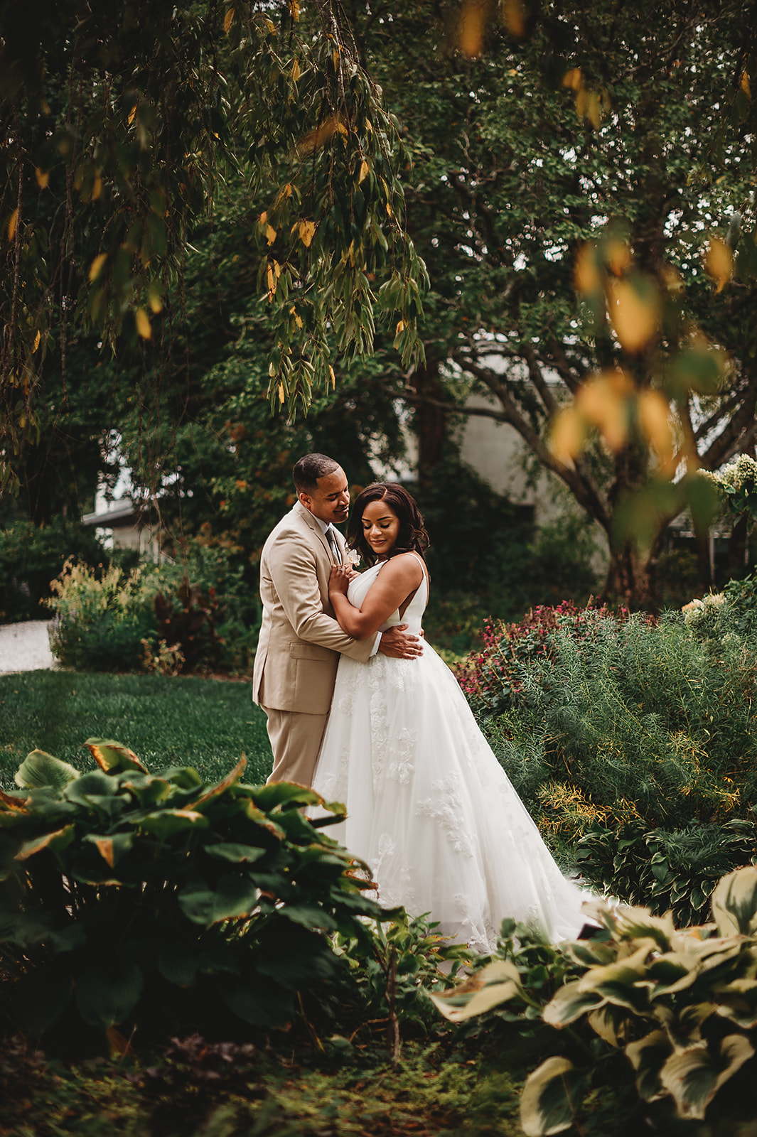 garden wedding pictures captured by baltimore wedding photographers with bride and groom embracing in a private garden wedding venue in Maryland